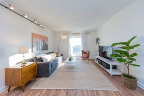 Living room with a pullout couch. Smart TV with with YouTube TV for cable. Queen air mattress also available. Plenty of seating plus a couple board games!