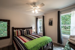 First bedroom, with a Queen bed and walk-in closet, is on the first floor.