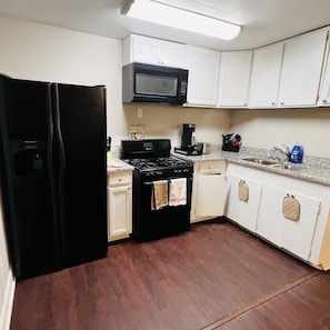 Fully stocked kitchen with a gas stove. 