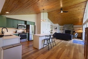 The kitchen & living room, with a stone fireplace.