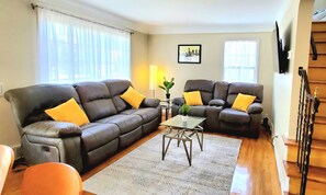 living room with two electric reclining couches 