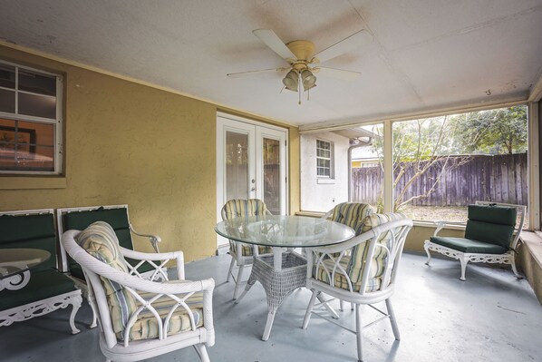 screened porch with table and chairs