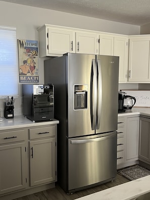 The refrigerator has an ice maker and there is also a separate wine fridge.
