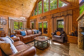Relax in style with breathtaking mountain views from the comfort of our open living space featuring a big screen TV, dining area, and large windows. Perfect for soaking in the natural beauty o