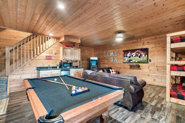 Unwind and have fun in our game room with a big screen TV, pool table, and triple bunk bed. Challenge friends to a game of pool or relax on the triple bunk. This is the perfect spot to enjoy i
