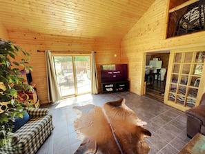 Fire place room facing patio featuring a 65in Roku smart tv. 