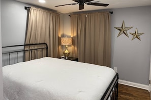 Queen bed and blackout curtains with a nice view of the soon-to-be fully fenced in backyard - great for pets