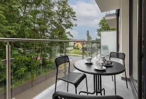 Spacious balcony with outdoor furniture.