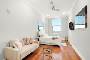 Smartly designed common space with a comfy couch, smart TV, and nice natural light.  All you have to do is log into your favorite streaming services and make it a TV night.