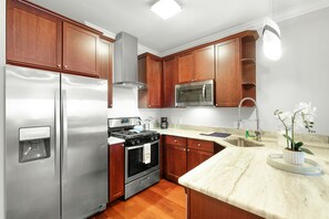 Fully stocked kitchen with microwave, stove, oven, coffee maker, toaster, fridge and freezer. Kitchen comes equipped with all pots, pans, cookware, dishware and flatware.  All the amenities you need to make a great home-cooked meal or a night to order in.