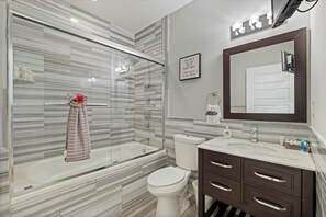 Nice clean modern bathroom with shower, jetted tub, toilet, vanity and TV.  