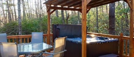 Covered 4 Person hot tub and outdoor dining on side deck