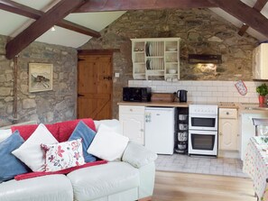 Open-plan design with exposed wood beams | Yr Hen Efail, Fishguard