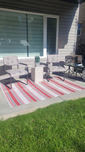 Patio space with tabletop BBQ.  Ketchup, mustard, mayo and BBQ sauce in fridge