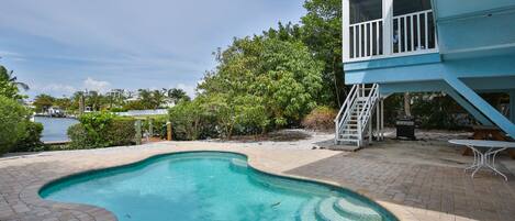 Crazy Mermaid - a SkyRun Anna Maria Property - Pool on the water - Private back yard with a pool overlooking the water and dock