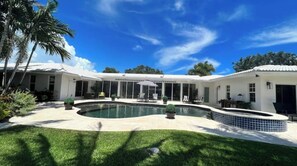 Welcome to your serene backyard oasis, featuring a tranquil setting with lush landscaping, an inviting pool, and a relaxing atmosphere.