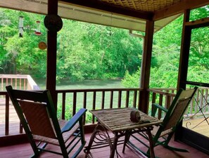 Rocking chairs are the perfect seats to sit by the river. 