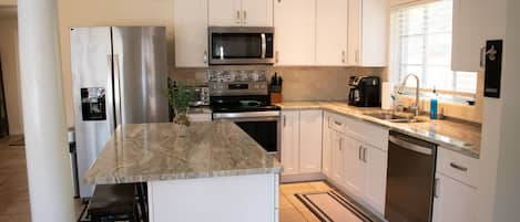 The kitchen is stocked with stainless steel appliances 