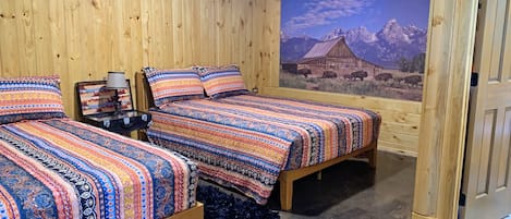 comfy queen sized beds in the Seek and Snore Cabin at The Lazy Buffalo, Cache OK