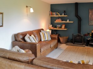 Living room with wood burner | Hollyhock Cottage, Thorns near Hawes