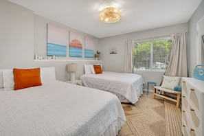 Bedroom overlooking front of condo with 2 queen beds