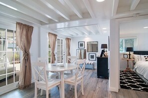 View of kitchen table, entry area and one bedroom.