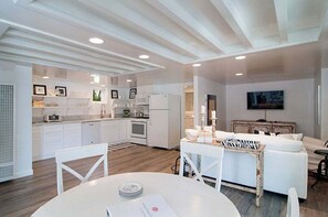 View entering unit of dining table, kitchen and living space.