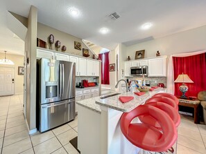 - Pull up a seat at the stylish breakfast bar and fuel up before a day of fun
- Fully stocked kitchen with sleek appliances and bold red accents throughout
- Perfect for sipping, snacking, or chatting while the chef whips up something tasty