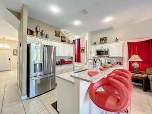 - Pull up a seat at the stylish breakfast bar and fuel up before a day of fun
- Fully stocked kitchen with sleek appliances and bold red accents throughout
- Perfect for sipping, snacking, or chatting while the chef whips up something tasty