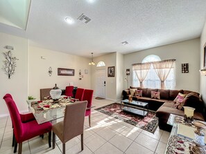 - Gather around the dining table dressed to impress, perfect for shared meals and stories
- Cozy sectional as natural light fills the room through arched windows
- Every corner is thoughtfully styled, blending warmth and comfort for memorable stays

