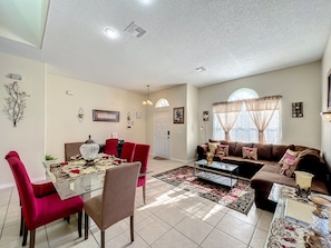 - Gather around the dining table dressed to impress, perfect for shared meals and stories
- Cozy sectional as natural light fills the room through arched windows
- Every corner is thoughtfully styled, blending warmth and comfort for memorable stays