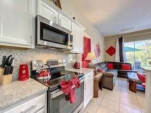 - Cook up memories in this sleek kitchen with granite counters and vibrant red accents
- Relax just steps away in a plush corner sofa with direct views of the pool area
- From morning coffee to midnight snacks, this space is made for comfort and connection