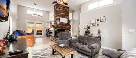 Living area with couch, loveseat, recliner, TV with Roku.