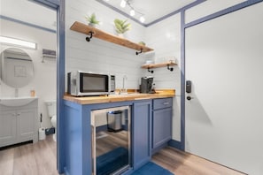 Our kitchenette features a microwave, keurig, and mini fridge. 