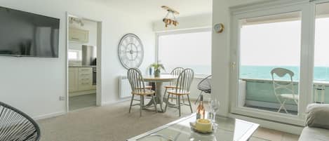 Open plan living/dining and kitchen with sea views