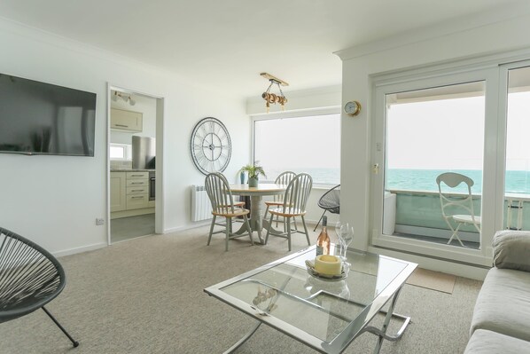 Open plan living/dining and kitchen with sea views