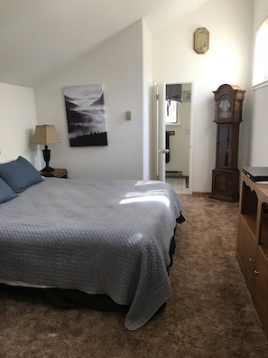 Upstairs Loft style bedroom (no door) with king size bed.