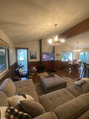 Family room with large sectional, gas fireplace and a flatscreen smart TV