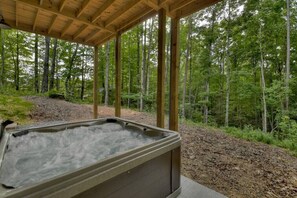 Relax in the hot tub and enjoy the surrounding forest