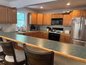 Kitchen with Island Bar in Private Home Near Loon Mountain