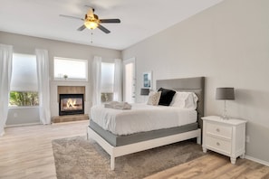 Master bedroom features Queen size bed, fireplace, and 65" Smart TV