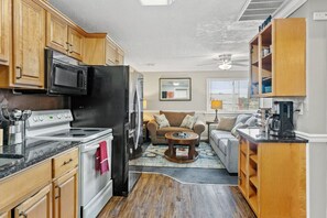 Reverse the view from our kitchen, offering a delightful peek into the living room. A seamless flow of spaces where culinary creations meet cozy relaxation.
