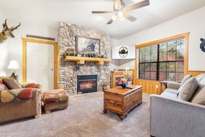 Living Room featuring a Seasonal Gas Fireplace, Sleeper Sofa, and Cable TV