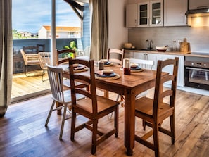 main room opening onto terrace kitchen view