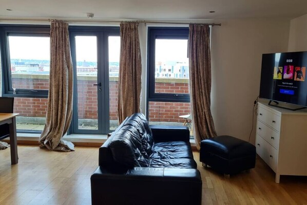 Living room with a comfortable sofa and TV where you can just chill and relax after a long day