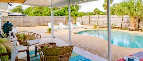 Fenced private pool with sandy back yard.