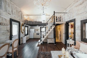 Open concept living, kitchen and stairs to upstairs loft