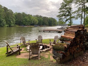 Huge water side fire pit with Adirondack chairs