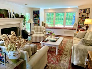 Comfortable living room with gas fireplace and built in book shelves