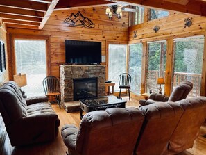 Living room w/ fireplace, foosball table, PS3, TV, and plenty of comfy seating.